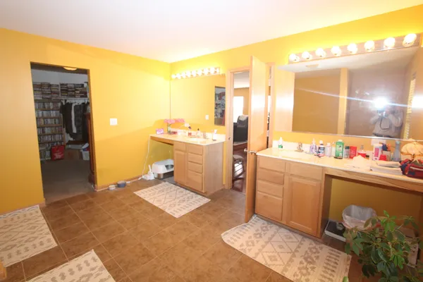 a spacious bathroom with a sink double vanity and a mirror