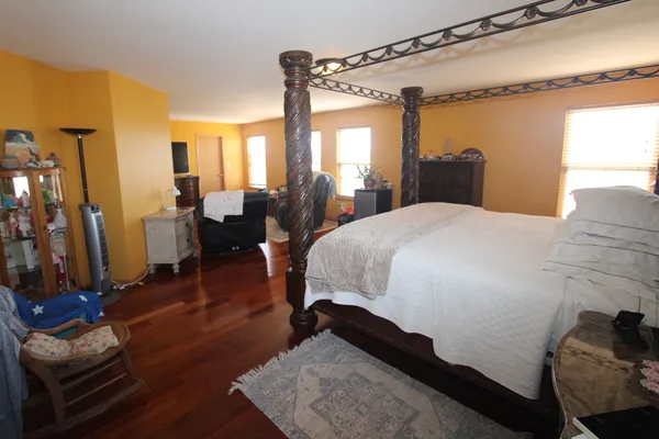 a bedroom with a bed window and a mirror