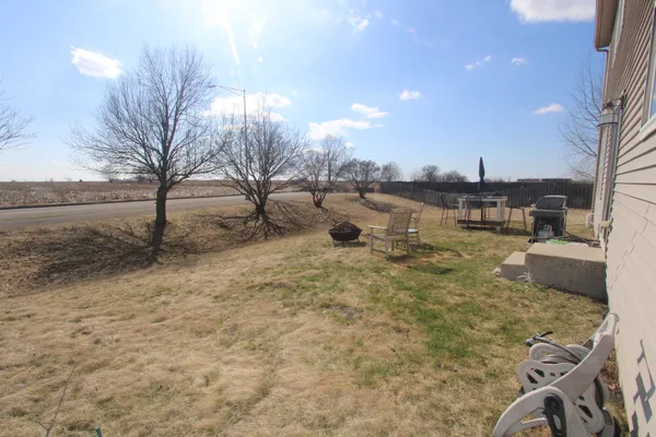 a view of a yard with table and chairs