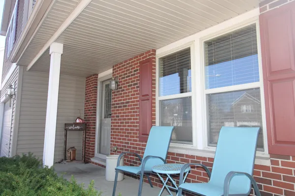 a view of a patio with a table and chairs and potted plants