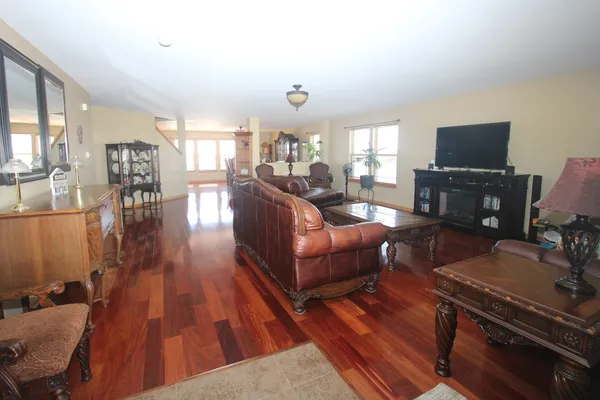 a living room with furniture a flat screen tv and a fireplace