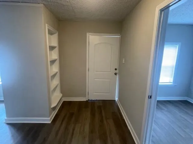 a view of bedroom with wooden floor