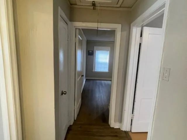 a view of a hallway with wooden floor