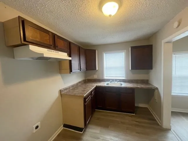 a kitchen with stainless steel appliances granite countertop a sink and a stove top oven