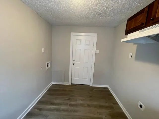 a view of a room with wooden floor