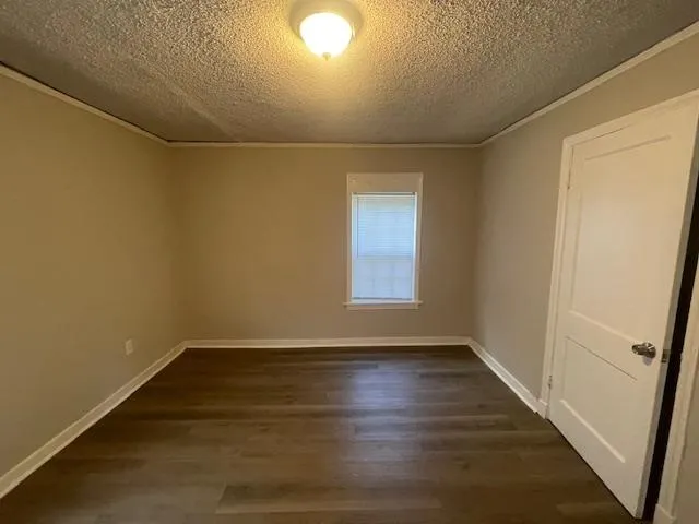 a view of room with window and hardwood floor