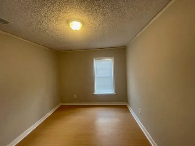 an empty room with a empty space and windows