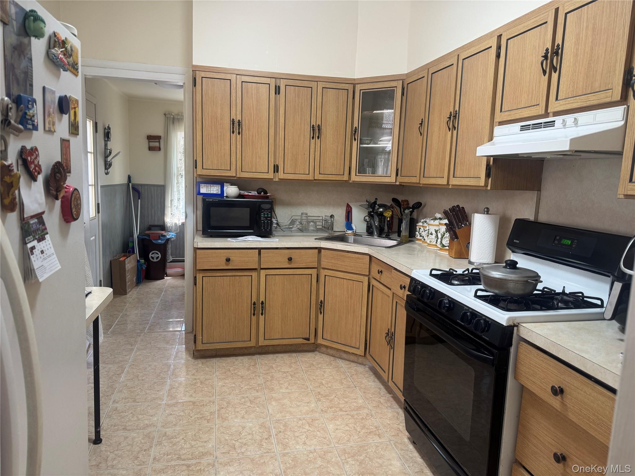 80-58 88th Road Queens, NY 11421 - Photo 8 of 21 a kitchen with stainless steel appliances granite countertop a stove a sink and a refrigerator