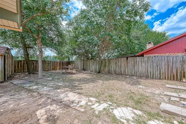 a view of a house with a yard and stairs