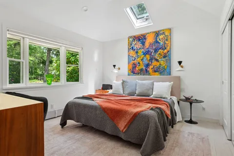 a bedroom with a bed and a window