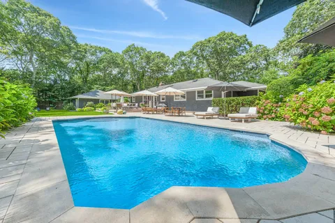 a view of a swimming pool with a yard