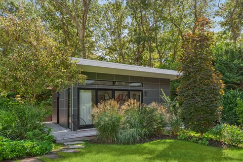 front view of house with a tree