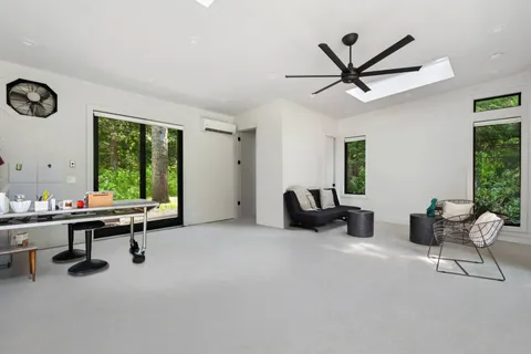 a view of a livingroom with workspace and a window