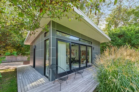 a view of house with wooden floor and outdoor seating