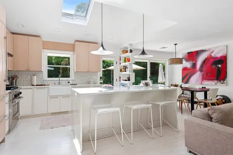 a kitchen with stainless steel appliances granite countertop a sink and white cabinets