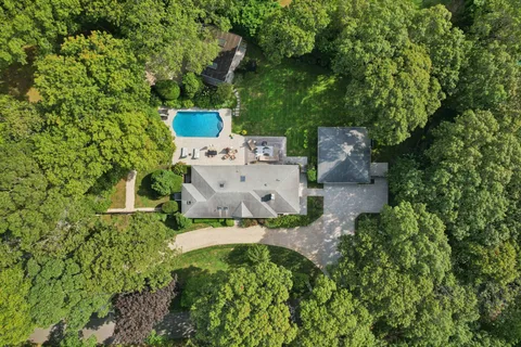 an aerial view of a house with a yard