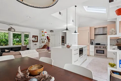 a living room with furniture and kitchen view