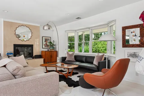 a living room with furniture fireplace and window