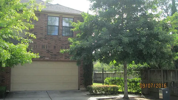 a front view of a house with plants