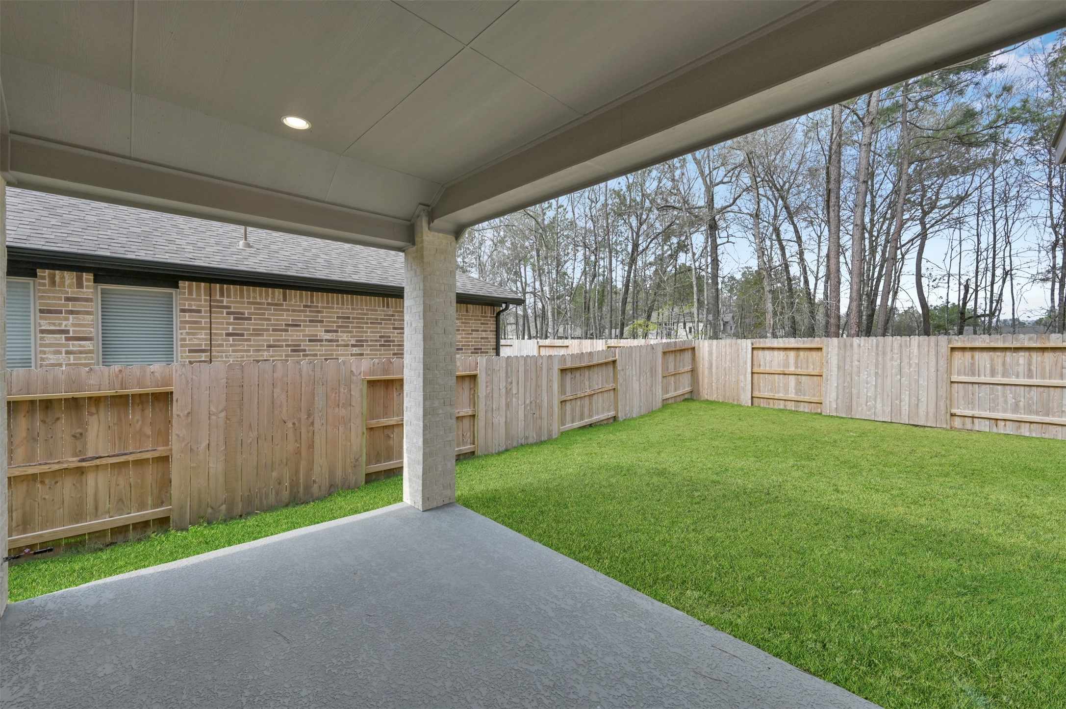 15715 Autumn Sun Conroe, TX 77302 - Photo 21 of 23 a view of a backyard with plants and large trees