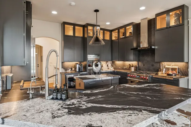a living room with furniture a fireplace and a dining table with wooden floor