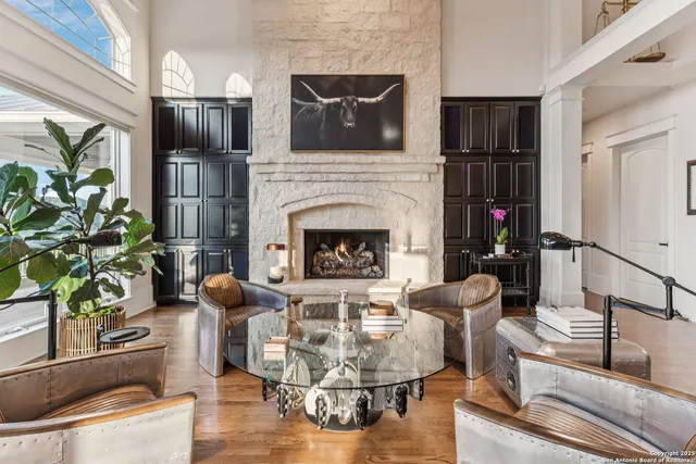 a living room with furniture a fireplace and a potted plant