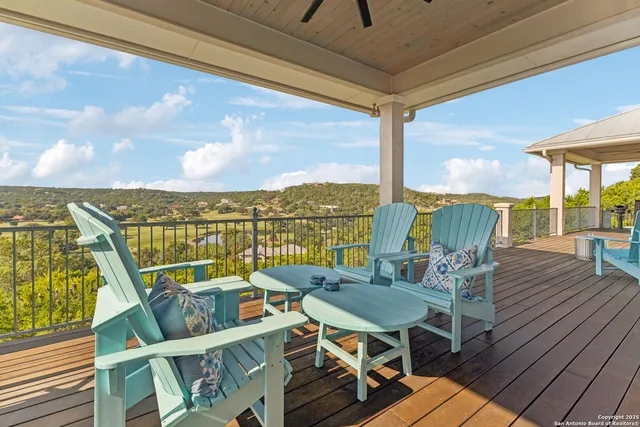 a view of a balcony with table and chairs and wooden floor