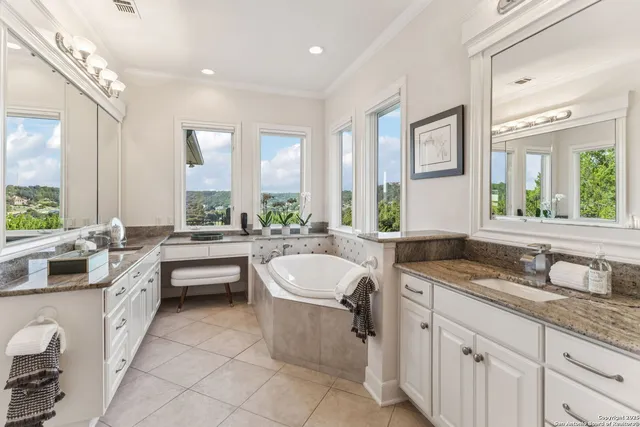 a bathroom with a granite countertop sink mirror and window