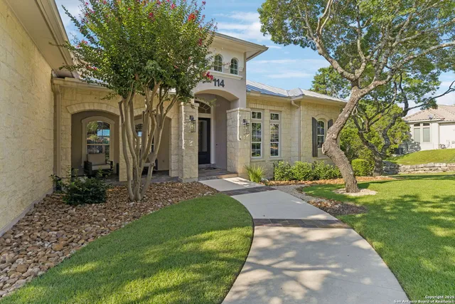 a front view of a house with garden