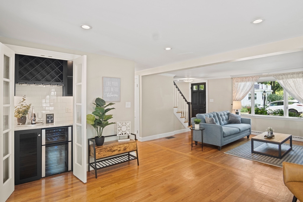 12 Renwick Road Melrose, MA 02176 - Photo 17 of 40 a living room with furniture a flat screen tv and a large window