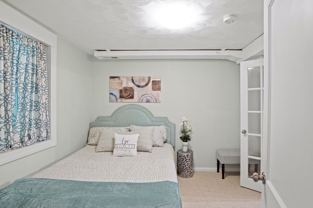 12 Renwick Road Melrose, MA 02176 - Photo 29 of 40 a bedroom with a bed and a table