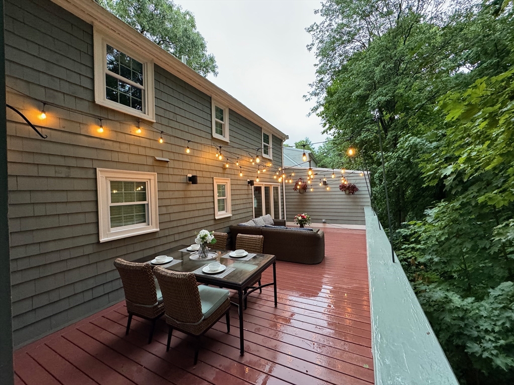 12 Renwick Road Melrose, MA 02176 - Photo 36 of 40 a view of a patio with table and chairs and wooden floor