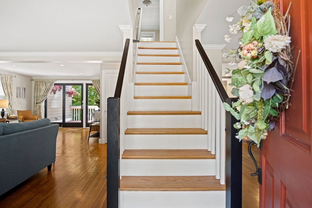 12 Renwick Road Melrose, MA 02176 - Photo 5 of 40 a view of staircase with wooden floor and a potted plant