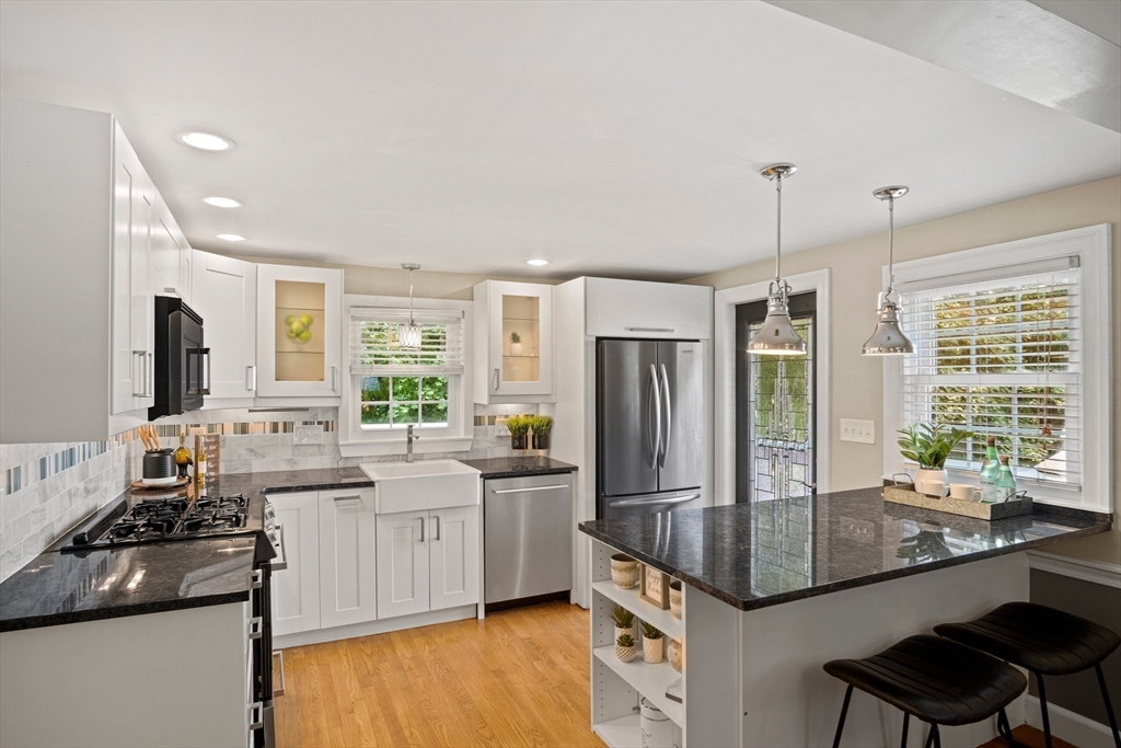 12 Renwick Road Melrose, MA 02176 - Photo 6 of 40 a kitchen with stainless steel appliances granite countertop a sink stove and refrigerator