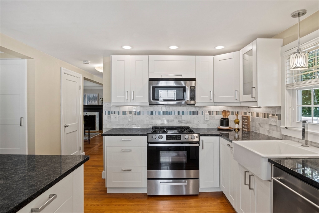 12 Renwick Road Melrose, MA 02176 - Photo 8 of 40 a kitchen with stainless steel appliances granite countertop a stove a sink and a microwave