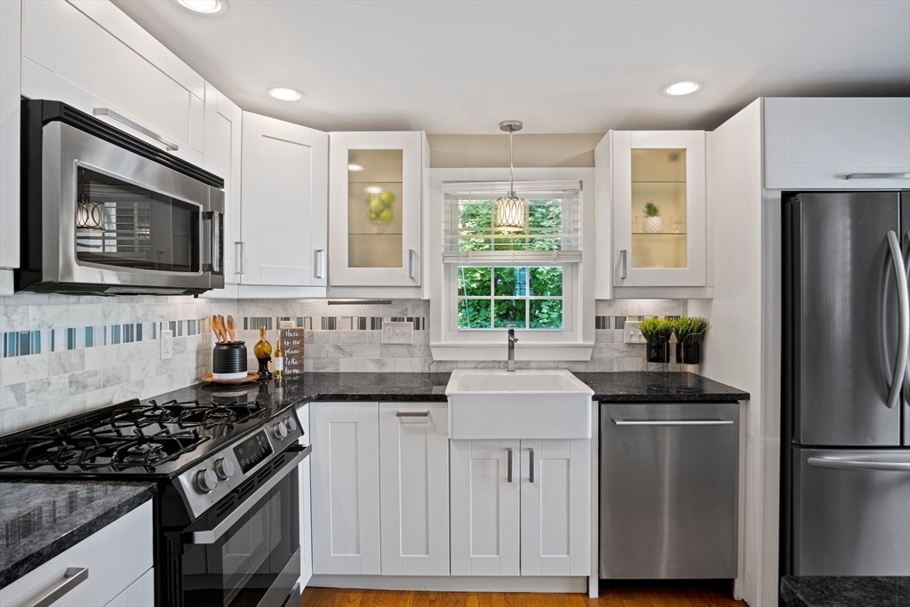 12 Renwick Road Melrose, MA 02176 - Photo 9 of 40 a kitchen with stainless steel appliances a sink stove and refrigerator