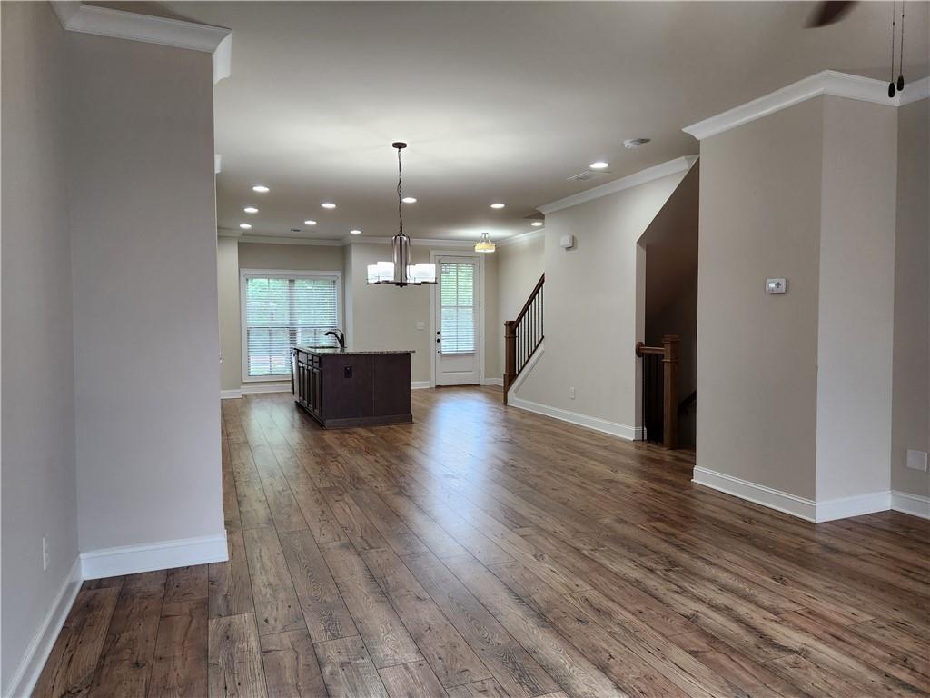 1323 Faircrest Way Suwanee, GA 30024 - Photo 7 of 16 a view of a living room a kitchen and a wooden floor