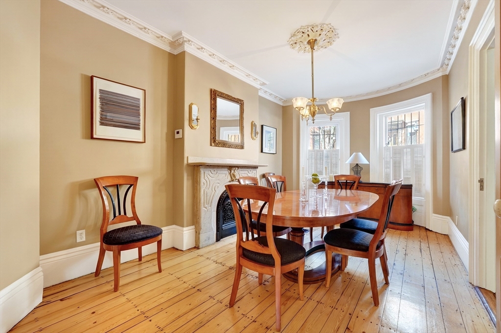 70 Montgomery Street Boston, MA 02116 - Photo 7 of 42 a dining room with furniture a chandelier and wooden floor
