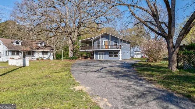 a view of house with backyard porch and sitting area