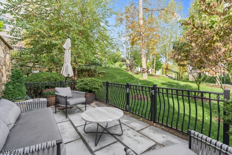 80 Claremont Road, Unit 802 Bernardsville, NJ 07924 - Photo 22 of 22 a view of a balcony with chairs and wooden fence