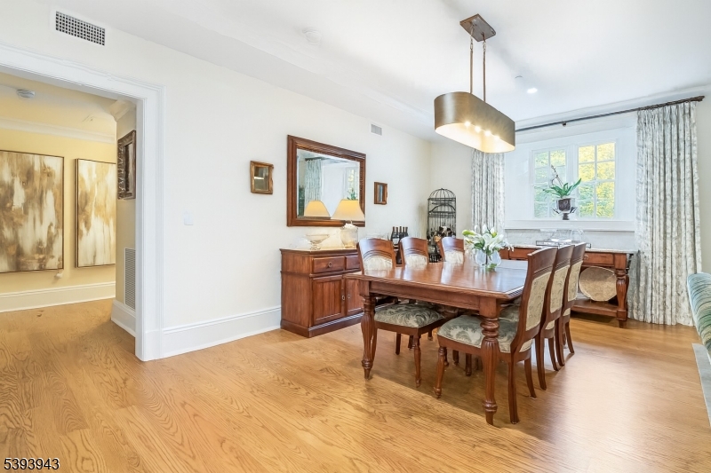 80 Claremont Road, Unit 802 Bernardsville, NJ 07924 - Photo 8 of 22 a view of a dining room with furniture window and wooden floor