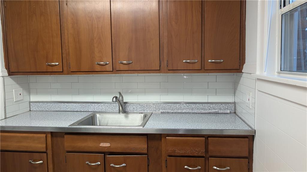4068 Brandon Road Pittsburgh, PA 15212 - Photo 11 of 16 a kitchen with a sink cabinets and a window