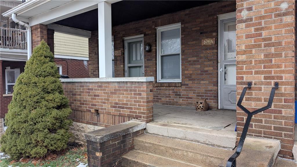 4068 Brandon Road Pittsburgh, PA 15212 - Photo 3 of 16 a view of a brick house with a small yard