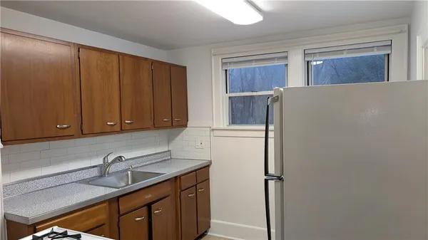 a kitchen with stainless steel appliances a refrigerator and a stove top oven