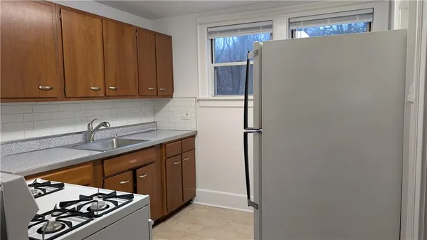 a kitchen with a sink cabinets and a window