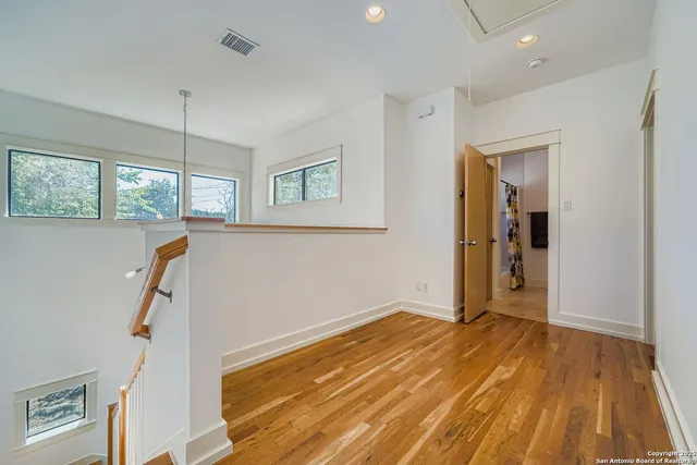 a view of a room with wooden floor and window