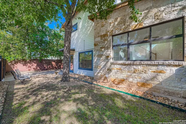 a view of a backyard with a tree
