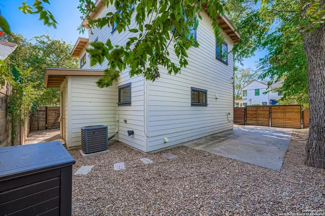 a view of a backyard with a tree