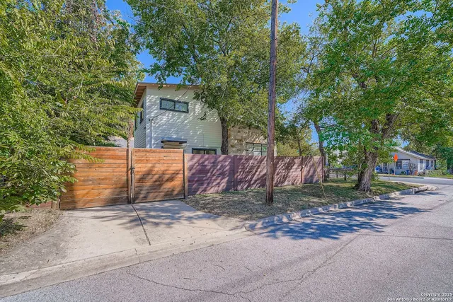 a view of a backyard with a tree