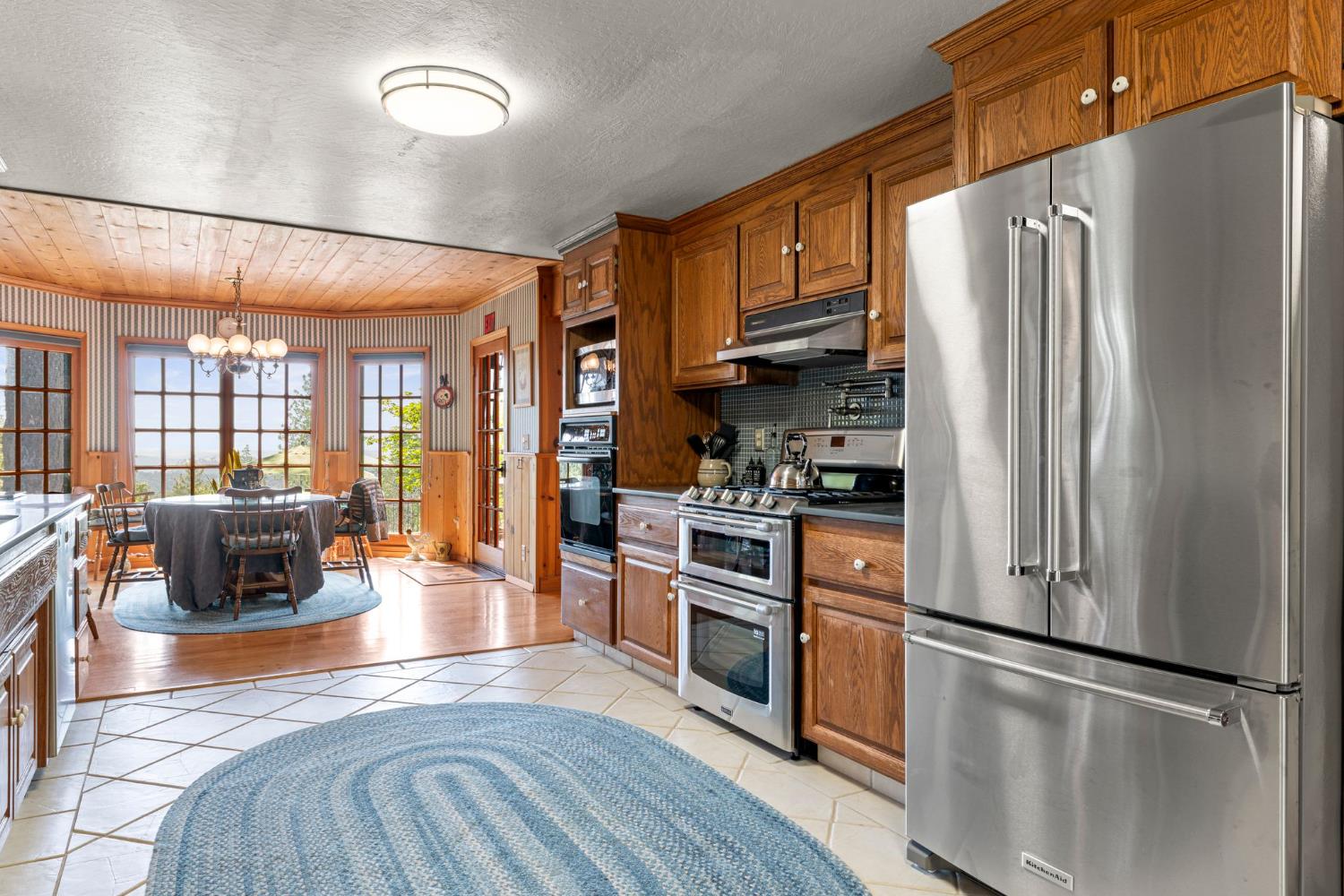 5821 Spanish Flat Road Placerville, CA 95667 - Photo 16 of 97 a kitchen with stainless steel appliances granite countertop a refrigerator stove and sink